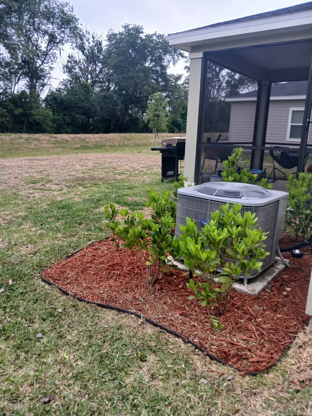After lawn and landscape bed care: mulch beds by the back porch