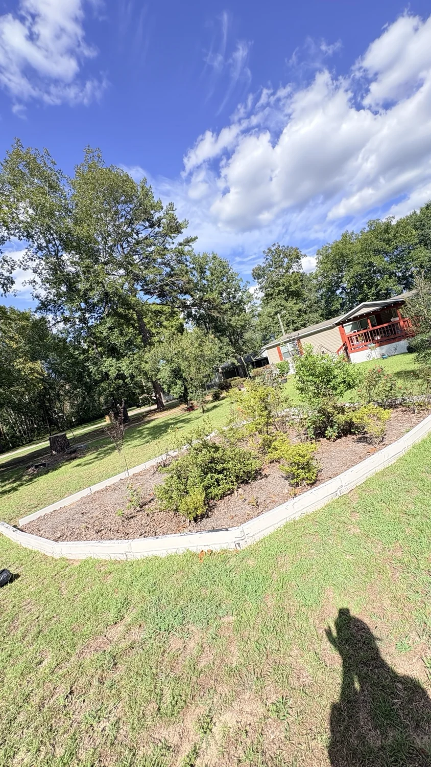 Before landscape bed cleanup: customer property before Fixed by Hicks lawn care